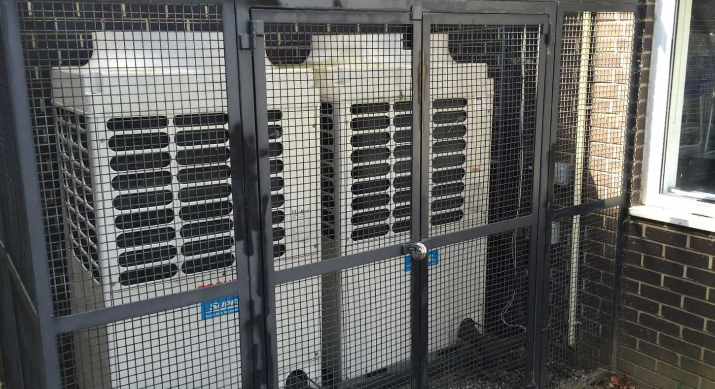 Air conditioning units in cage