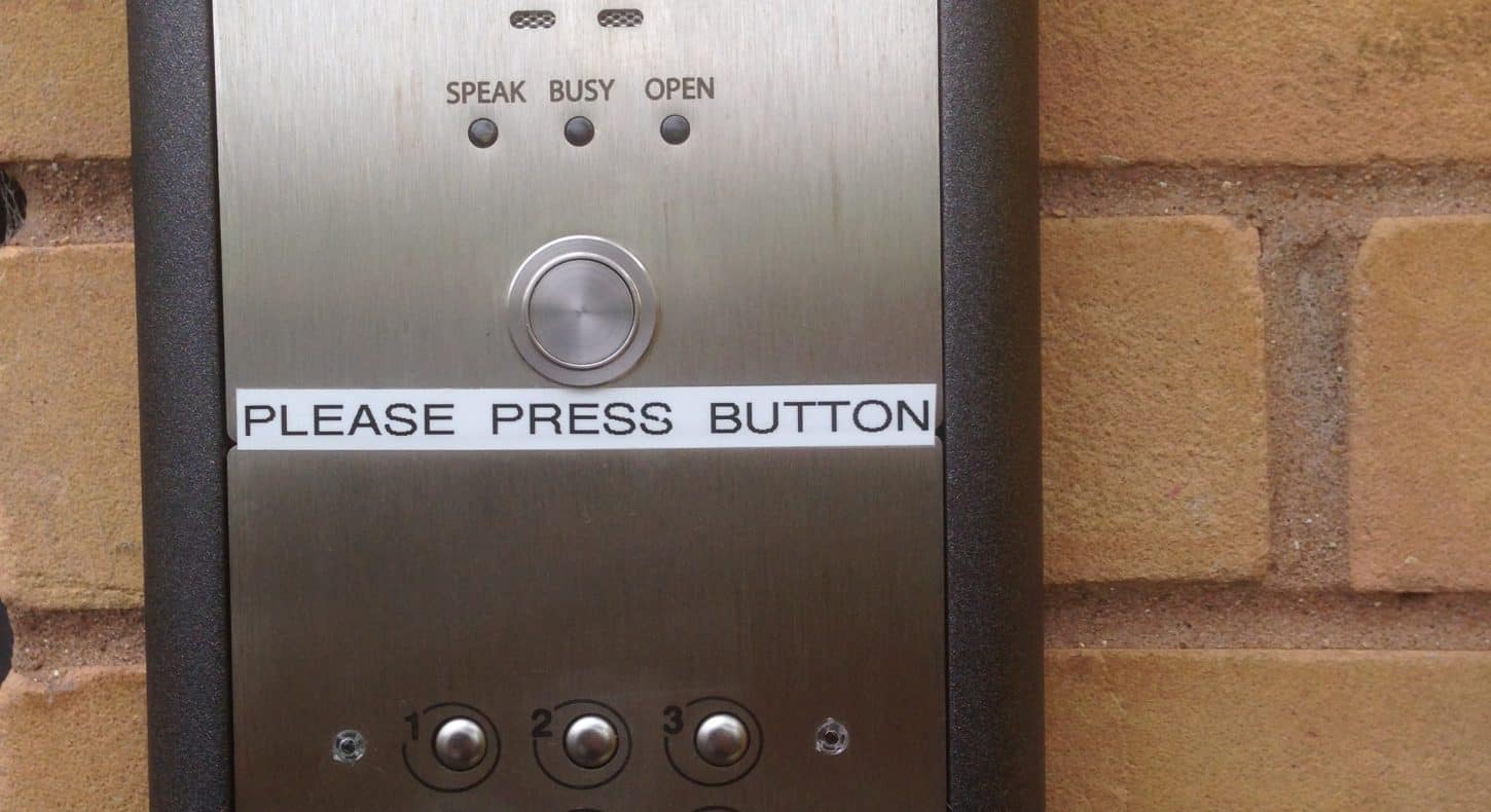 Access control keypad equipment on brick wall.