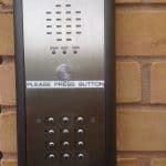 Access control keypad equipment on brick wall.