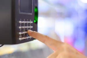 finger pressing buttons on keypad