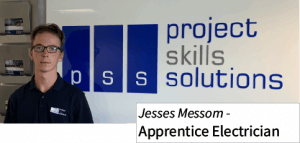 Apprentice in front of business sign 