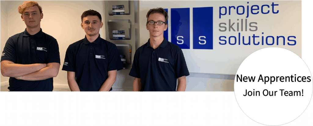 New apprentices standing in front of business sign