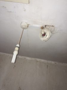 EICR Fault Damaged Smoke Alarm Hanging from ceiling